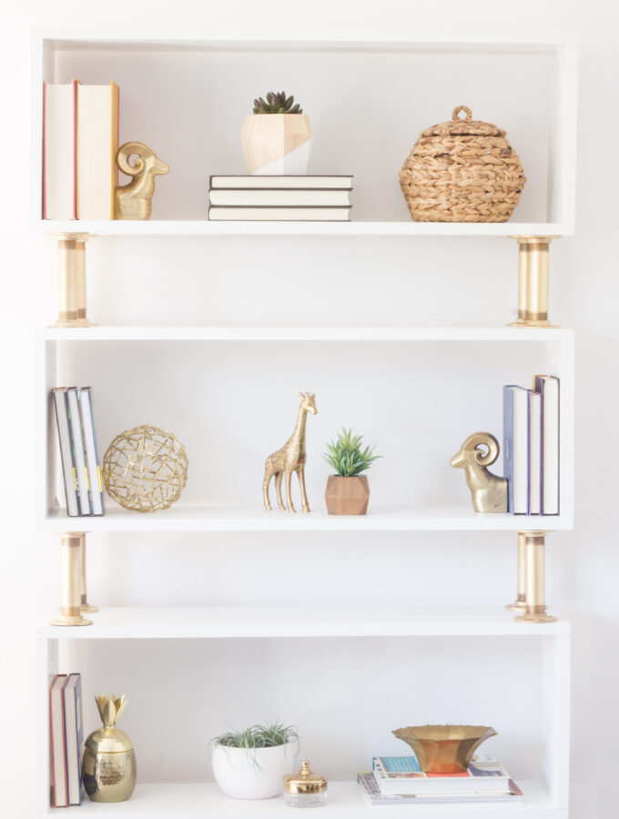 Learn how to build this "modern glam" DIY pipe bookshelf!
