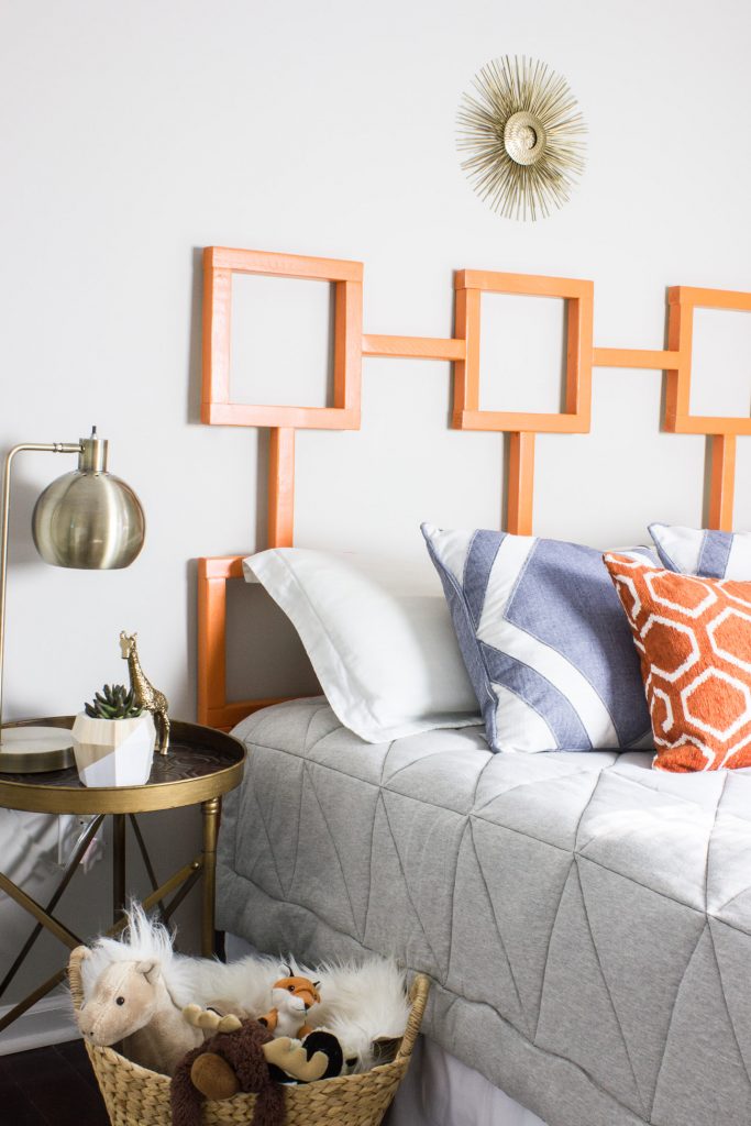 Learn how to make this DIY headboard with a fun geometric shape! This one is a yummy orange but you could customize it with any finish or color you like.