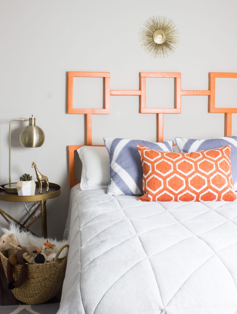 Learn how to make this DIY headboard with a fun geometric shape! This one is a yummy orange but you could customize it with any finish or color you like.