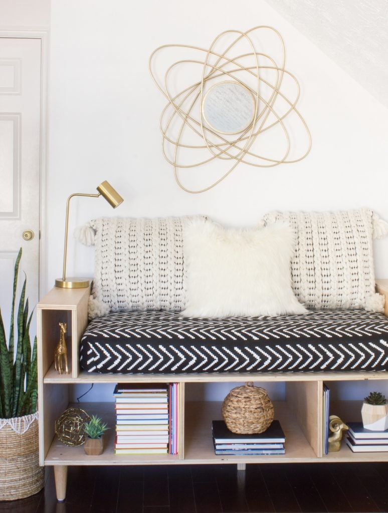 Upcycle your old crib mattress by building this DIY mini daybed! This step by step tutorial will show you how.