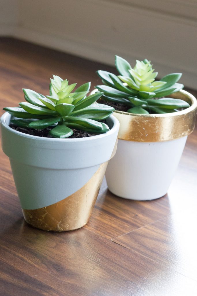 Learn how to make these gorgeous DIY painted & gold leaf succulent pots!