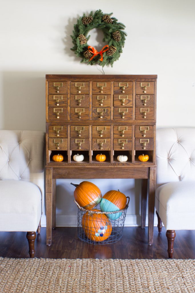 I absolutely love this card catalog decorated for fall! The mini pumpkins, painted and gold leaf pumpkins, and Kennedy Fir Wreath from Tree Classics are beautiful!